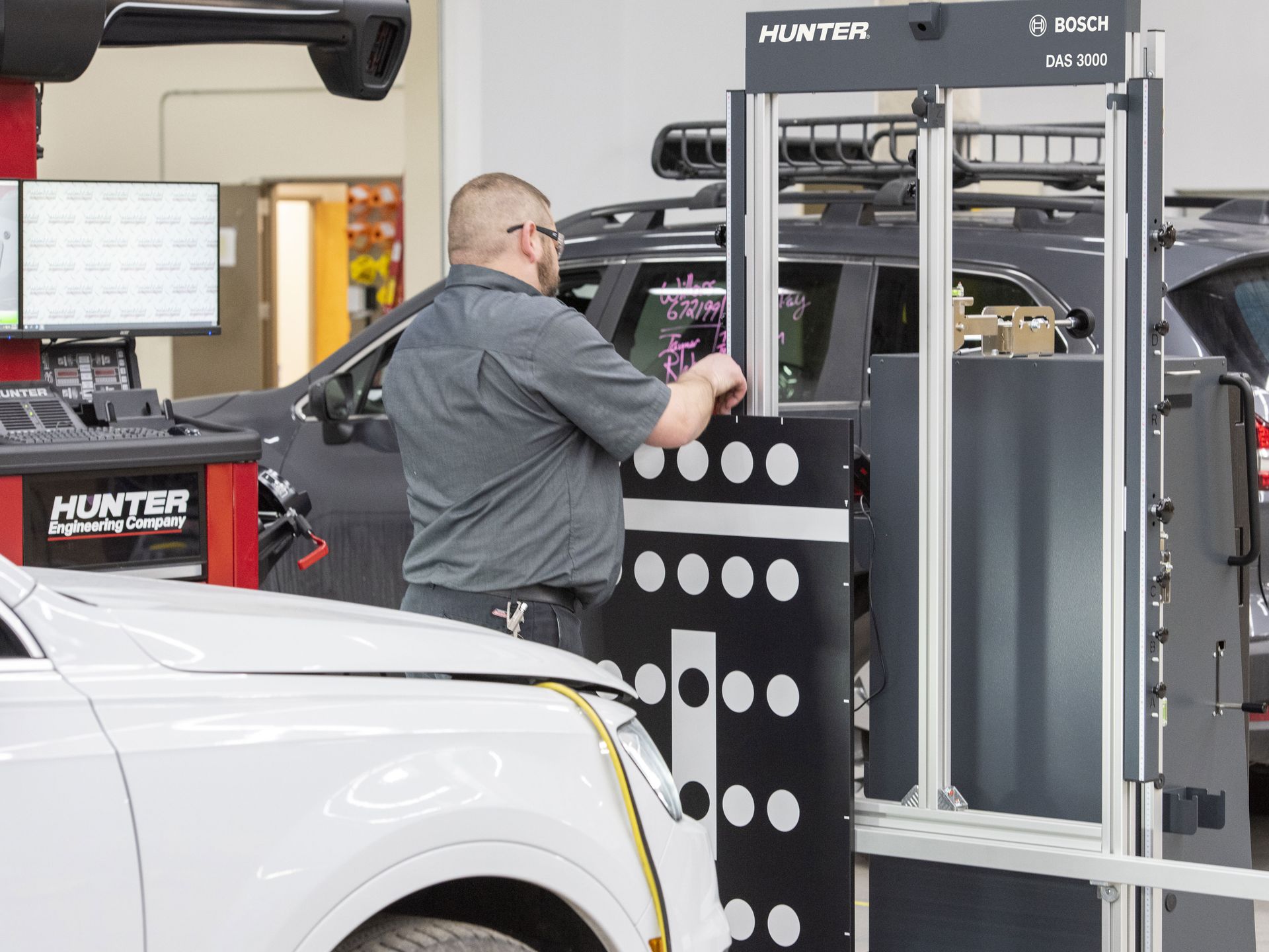 A man is working on a car in a garage. | Ruckersville, VA | KEL-CAM Tire & Auto