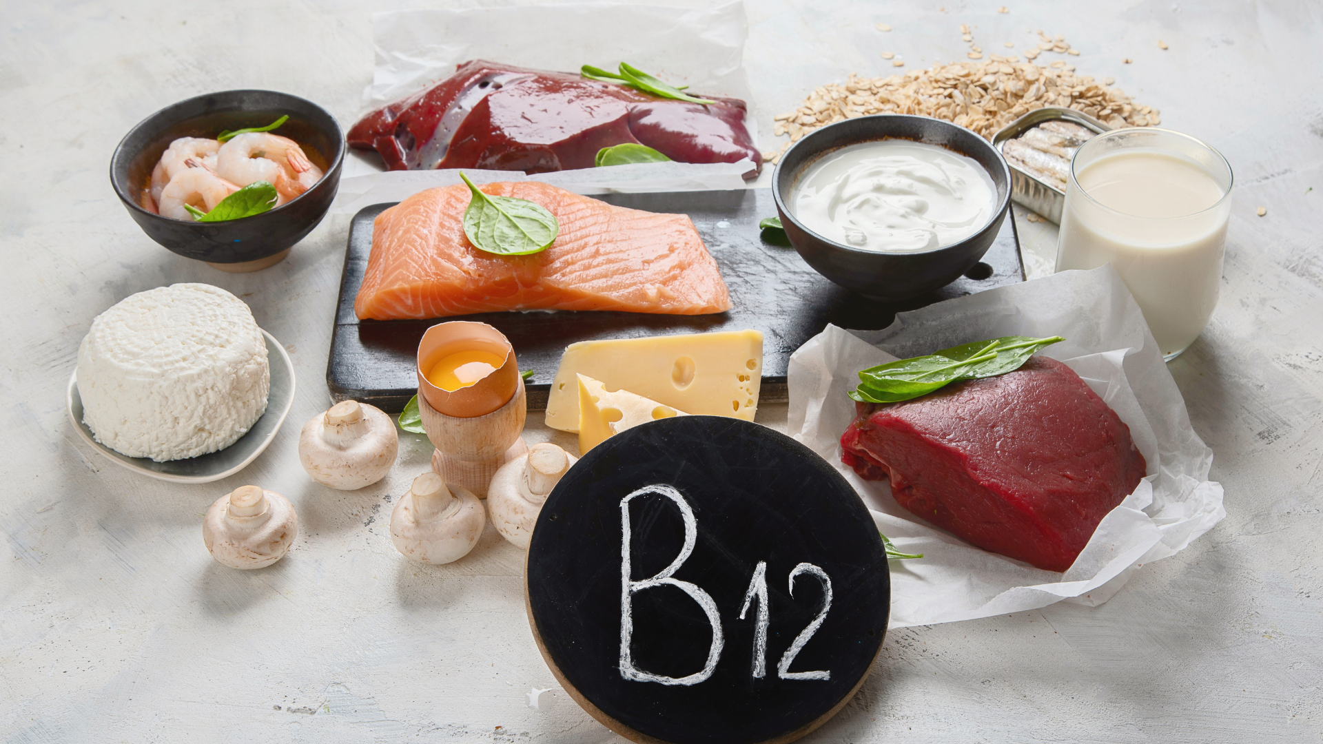 A variety of foods containing vitamin b12 are on a table.