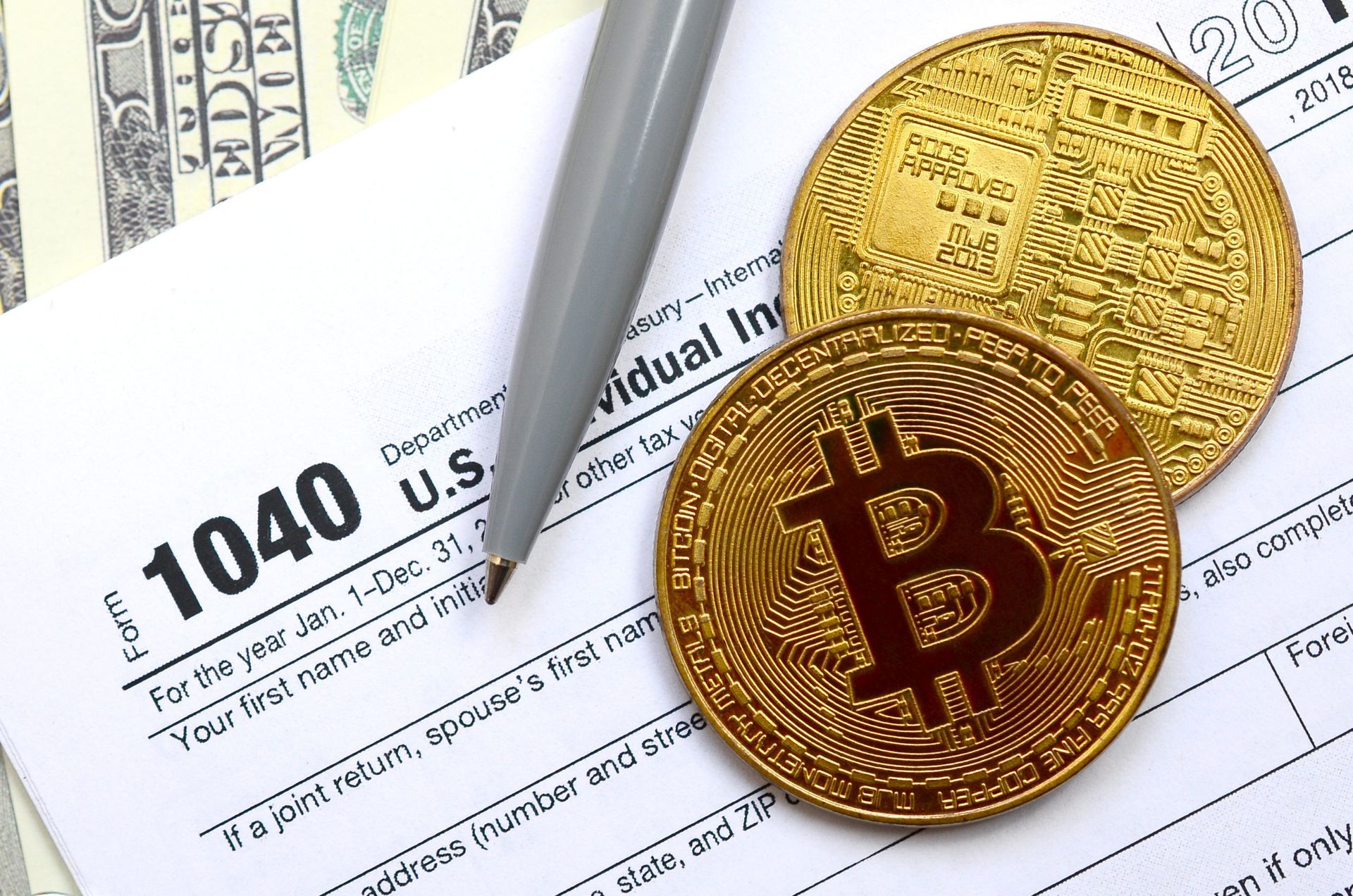 digital composite of a tax form with cryptocurrency symbols on it