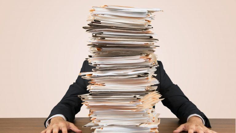 stack of tax documents preparing for IRS tax debt relief