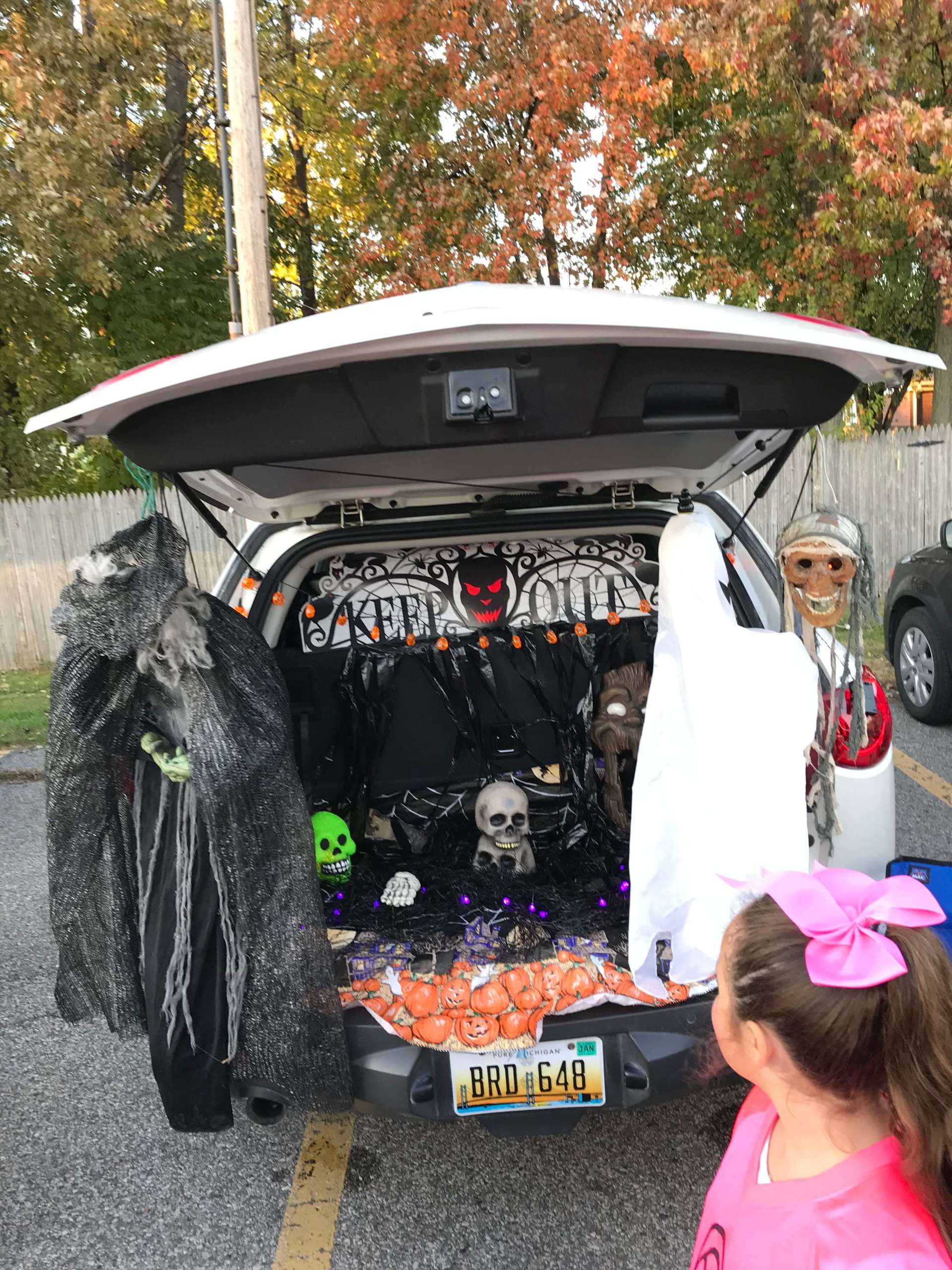A trunk decorated for halloween with a new jersey license plate