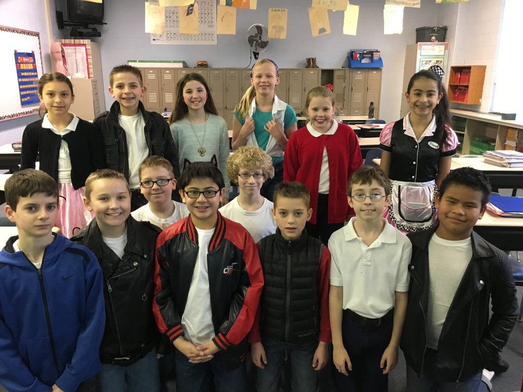 A group of children posing for a picture in a classroom