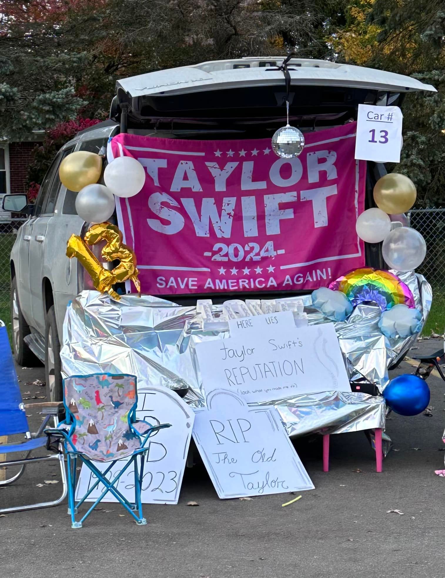 A large pink sign that says Taylor Swift.