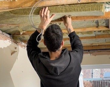 Adding acoustic mineral wool to ceiling joists