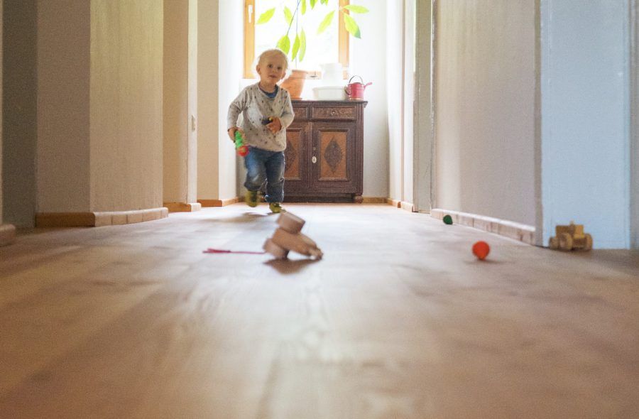 Child running on wooden floor