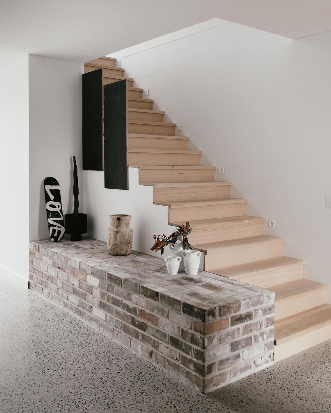 Interior brick wall at the bottom of some stairs— Premier Bricks, Blocks & Pavers In Heatherbrae, NSW