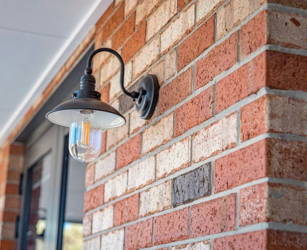 A brick wall with a light on it — Premier Bricks, Blocks & Pavers In Heatherbrae, NSW