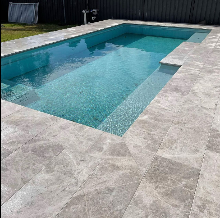 A Stone Walkway With A Brick Wall In The Background — Premier Bricks, Blocks & Pavers In Heatherbrae, NSW