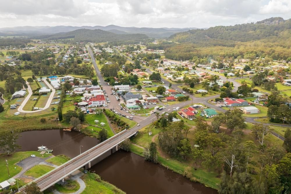 An Aerial View Of A Small Town With A Bridge Over A River — Premier Bricks, Blocks & Pavers In Hawks Nest, NSW