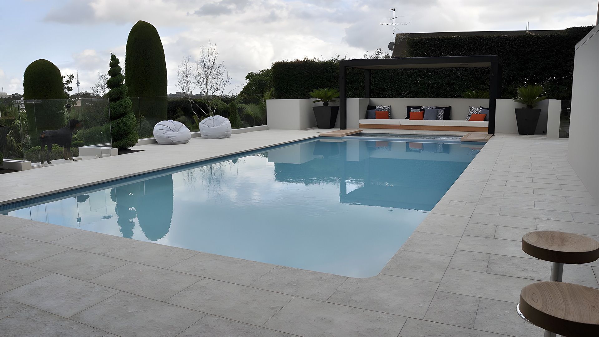 A Brick Walkway Leading To A House With A Wooden Deck— Premier Bricks, Blocks & Pavers In Heatherbrae, NSW