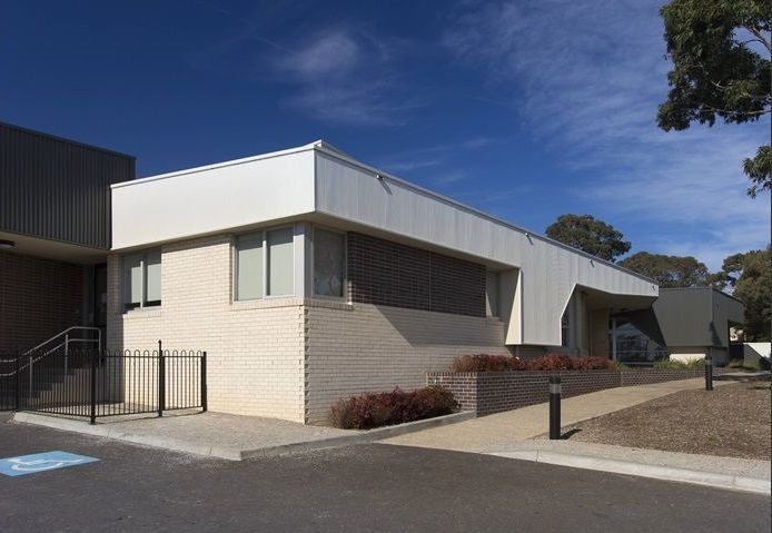 Building with brick and white panel exterior — Premier Bricks, Blocks & Pavers In Heatherbrae, NSW