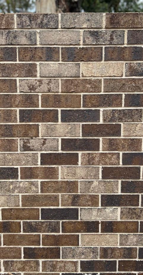 A Pile Of Red Bricks Sitting On Top Of A Wooden Pallet — Premier Bricks, Blocks & Pavers In Heatherbrae, NSW