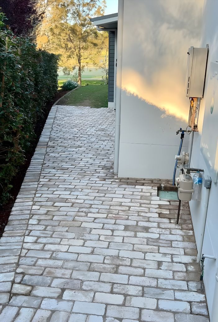 A White Brick Walkway Leading To A House — Premier Bricks, Blocks & Pavers In Huntlee, NSW