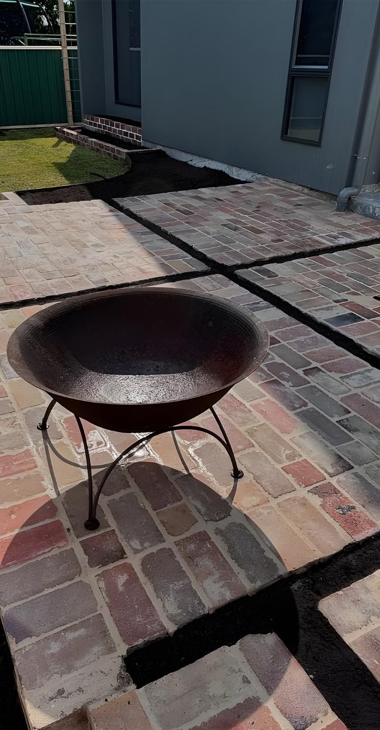 A Fire Pit Is Sitting On Top Of A Brick Patio — Premier Bricks, Blocks & Pavers In Newcastle, NSW