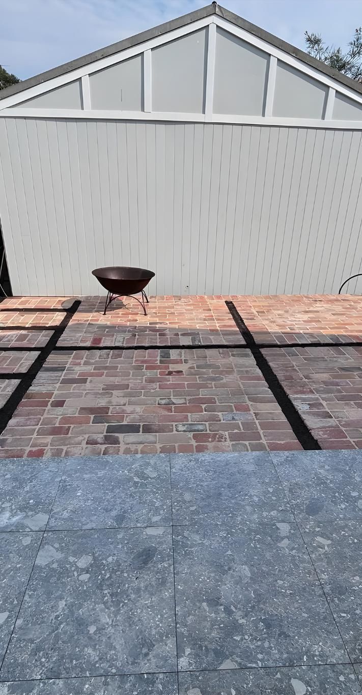 A Brick Patio With A Fire Pit And A Shed In The Background — Premier Bricks, Blocks & Pavers In Port Stephens, NSW