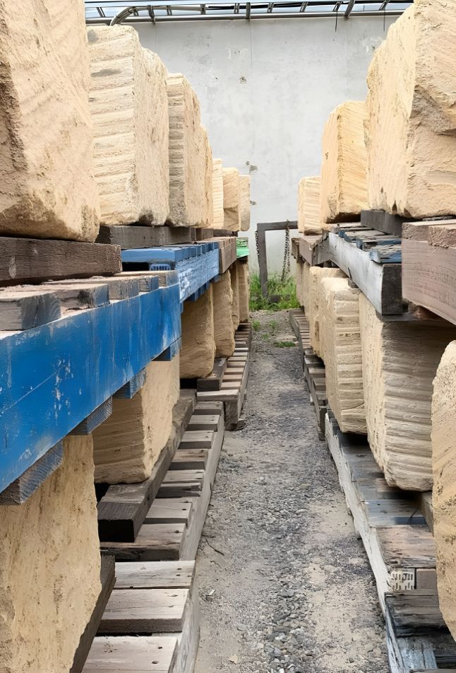A Warehouse Filled With Lots Of Bricks And Wooden Pallets — Premier Bricks, Blocks & Pavers In Lochinvar, NSW