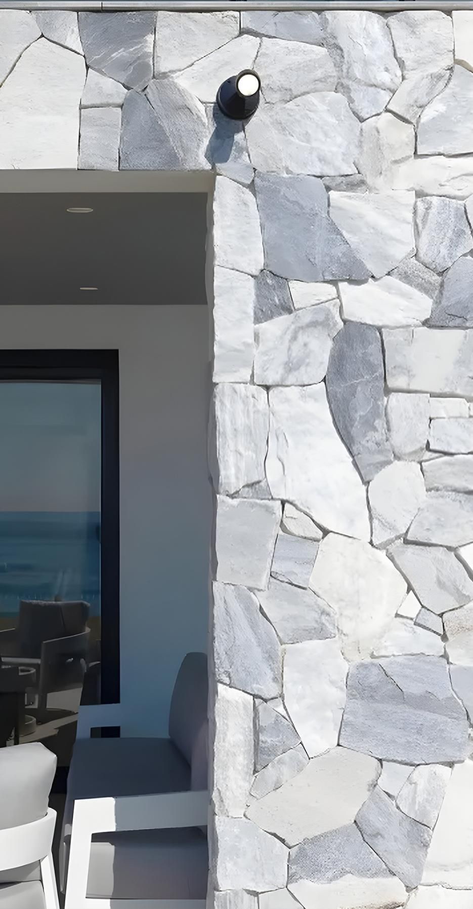 A House With A Stone Wall And A Large Window — Premier Bricks, Blocks & Pavers In Cessnock, NSW