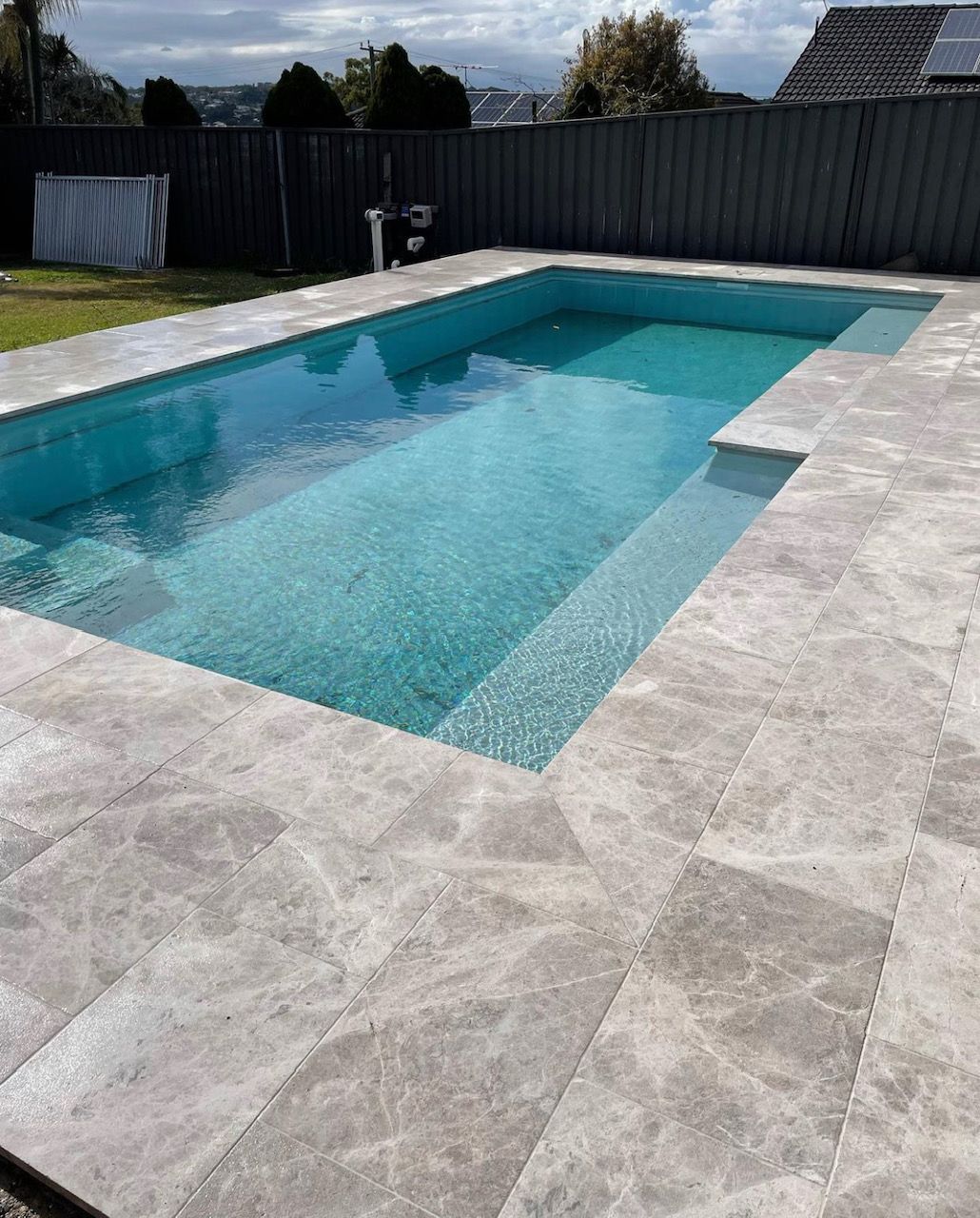 Tundra Grey tiles around a pool— Premier Bricks, Blocks & Pavers In Heatherbrae, NSW