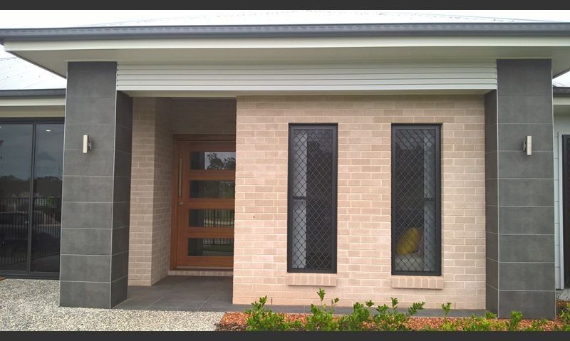 Beige brick facade with dark gray pillars — Premier Bricks, Blocks & Pavers In Heatherbrae, NSW