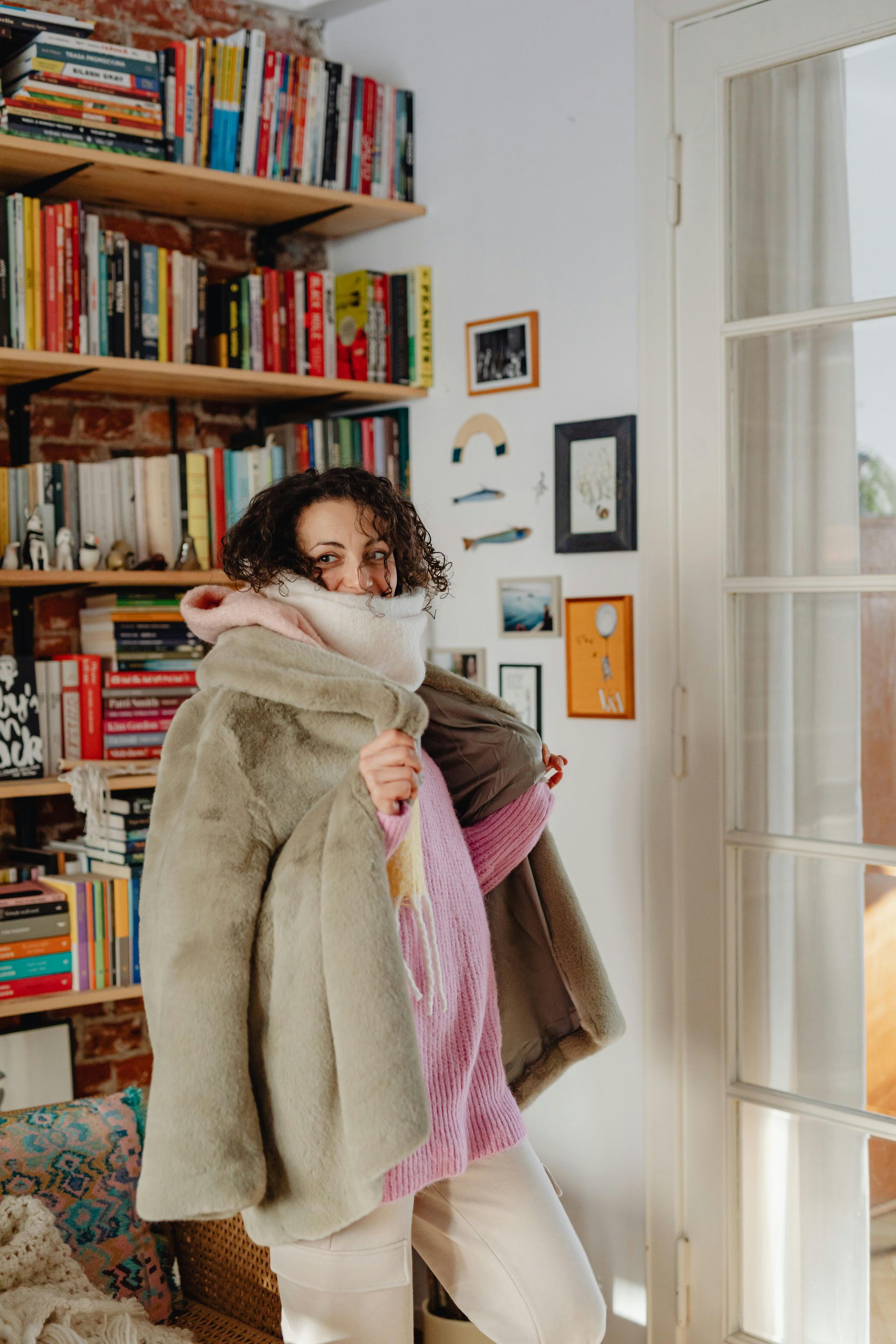 A woman wearing winter clothes inside a cold home in Australia. 