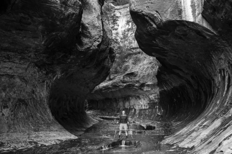  Man Stands in the middle of a Canyon