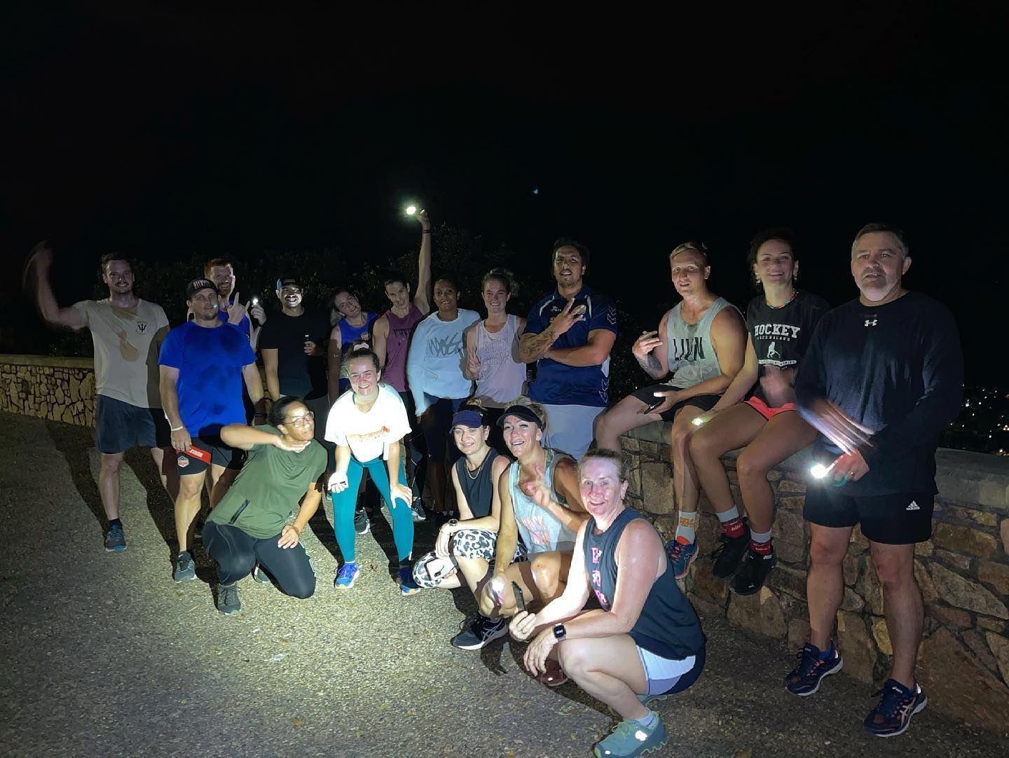 A Group Of People Are Posing For A Picture At Night — Elev8ed Fitness In Currajong, QLD