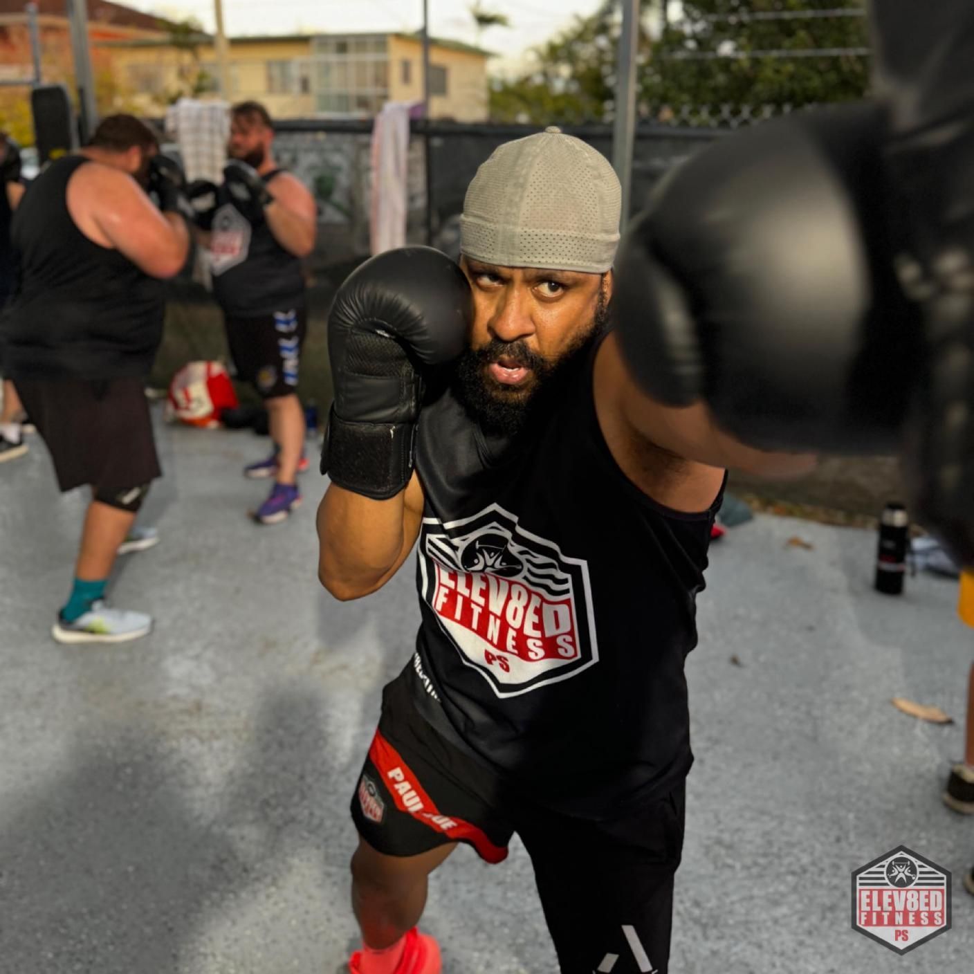 A Man Wearing Boxing Gloves — Elev8ed Fitness In Currajong, QLD