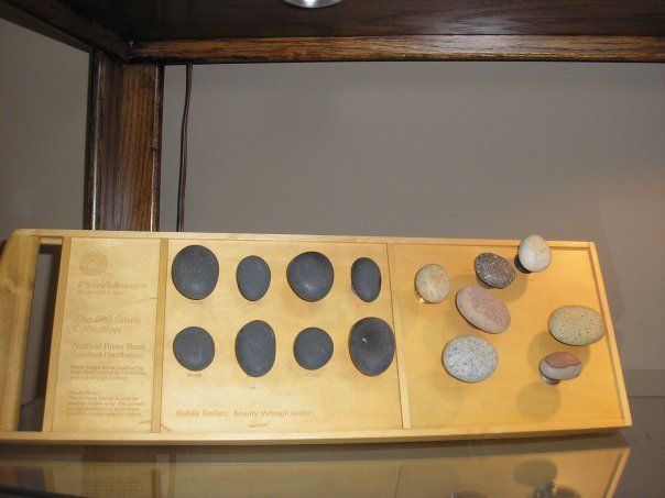 A wooden board with circles on it is displayed on a shelf