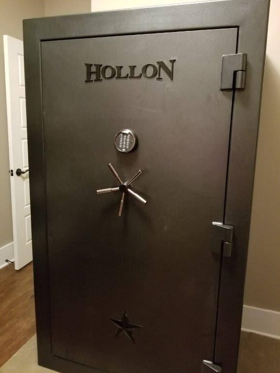 A hollon safe is sitting in a room next to a door.