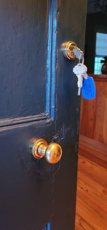 A close up of a door with keys hanging from it.