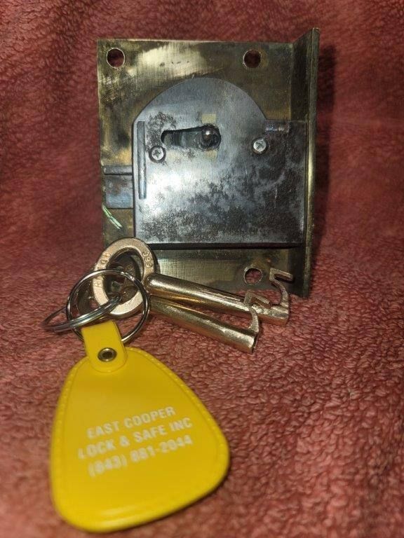 A yellow keychain that says east cooper lock & safe inc