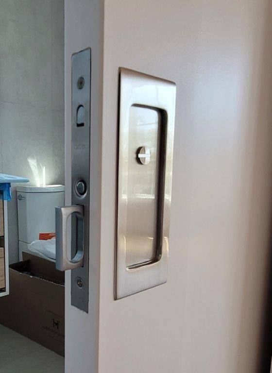 A sliding door with a stainless steel handle on it.
