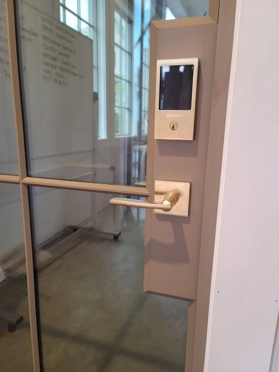 A door with a handle and a monitor on it