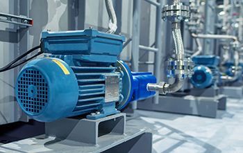 A close up of a blue electric motor in a factory.