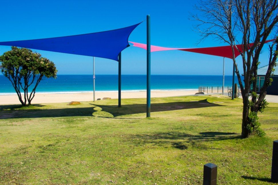 Red Shade Sails Over Green Grass — Canobolas Canvas In Orange, NSW