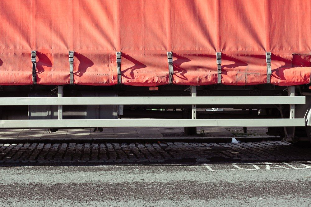 Red Tarp Side Of A Truck, Metal Framework, Black Road With Brick Border — Canobolas Canvas In Orange, NSW