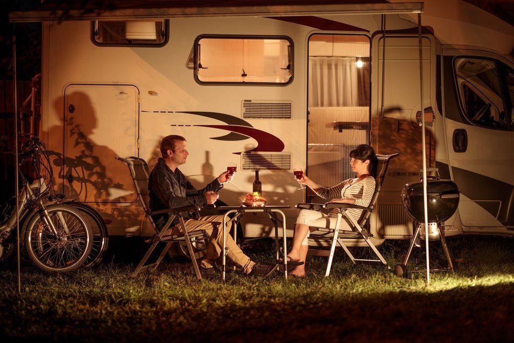 Couple Toasting With Wine Outside Of A Camper Van At Night — Canobolas Canvas In Orange, NSW