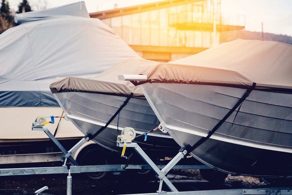 Two Gray Boats On Trailers, Covered With Black And White Tarps — Canobolas Canvas In Orange, NSW