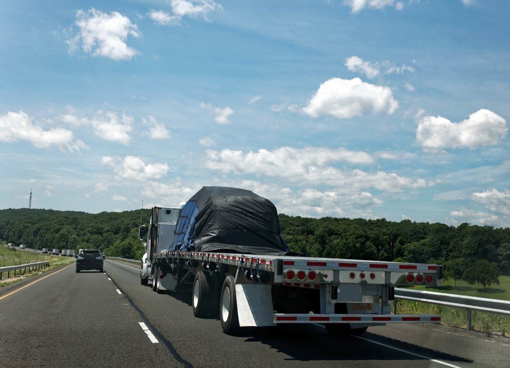 A Flatbed Truck Hauling A Tarp-covered Cargo — Canobolas Canvas In Orange, NSW