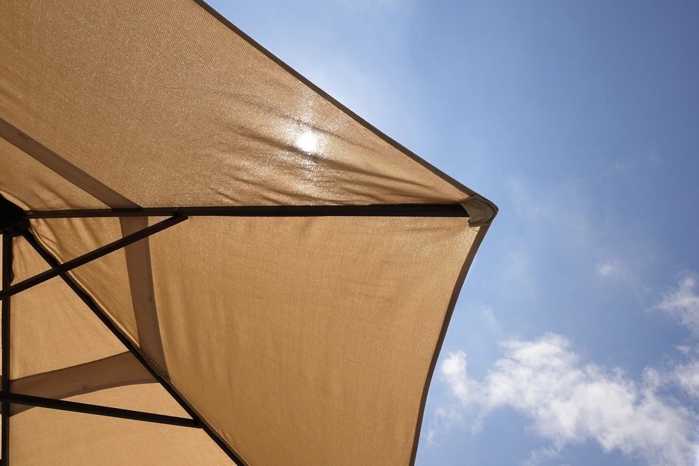 Tan Patio Umbrella Against A Bright Blue Sky — Canobolas Canvas in Orange, NSW