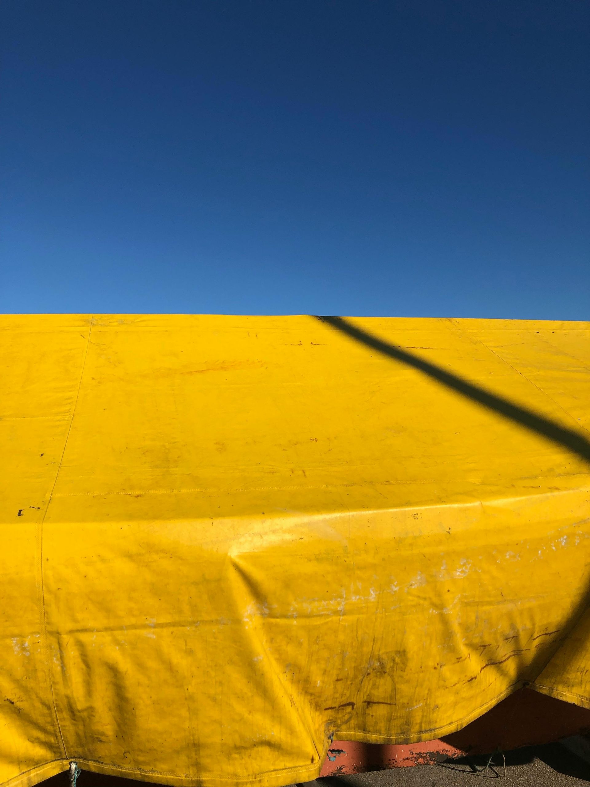 Bright Yellow Tarp Against a Clear, Blue Sky — Canobolas Canvas In Orange, NSW