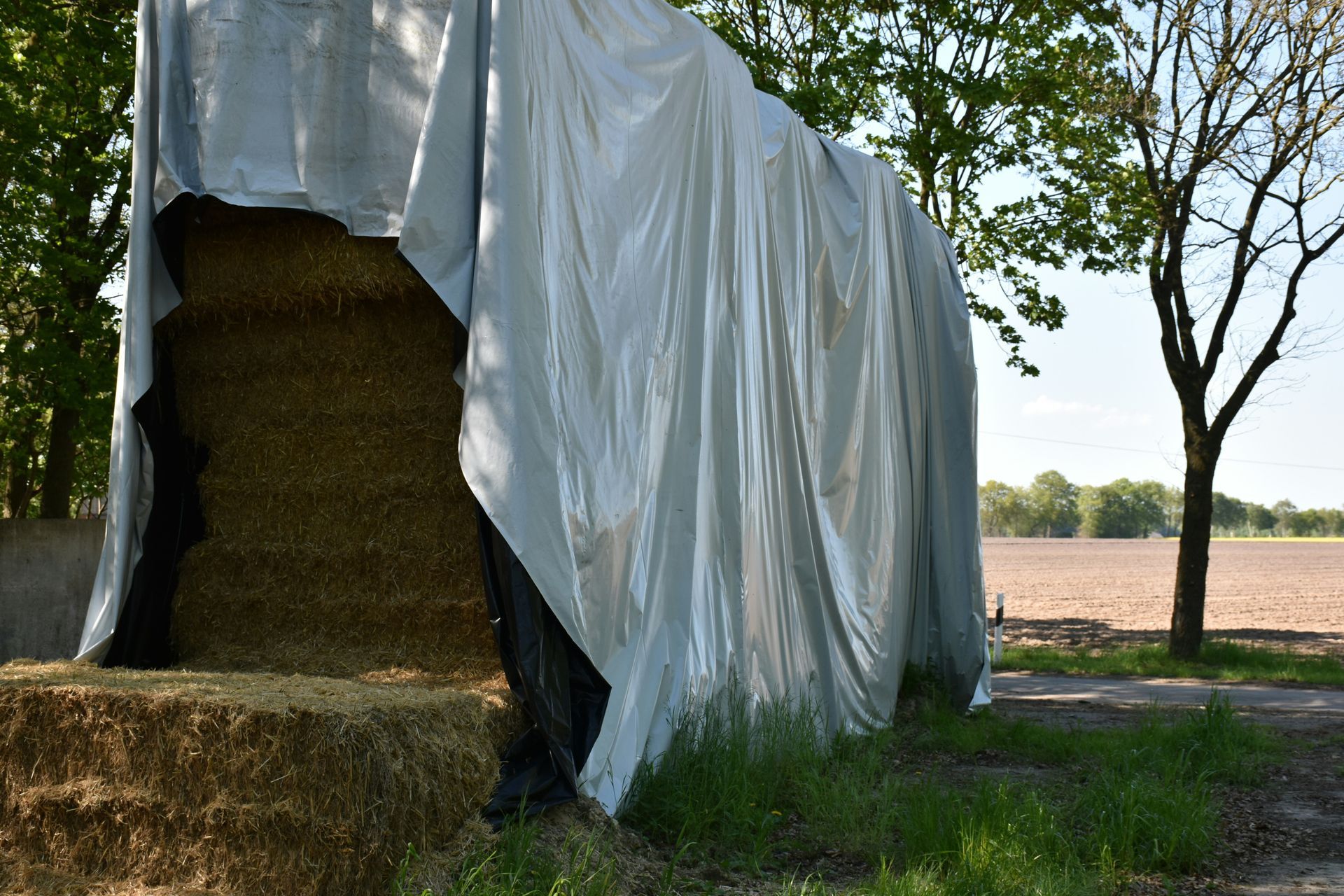 Hay Bales Stacked and Covered With a Silver Tarp — Canobolas Canvas In Orange, NSW