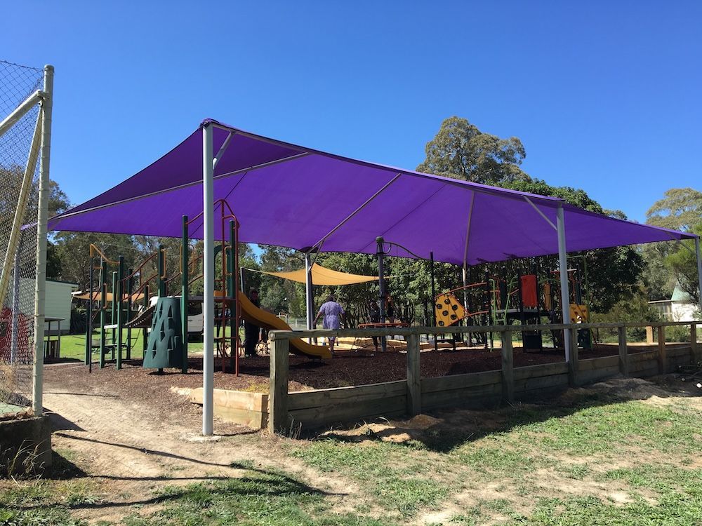 Purple Shade Sail Covers a Children's Playground with Slides — Canobolas Canvas In Orange, NSW