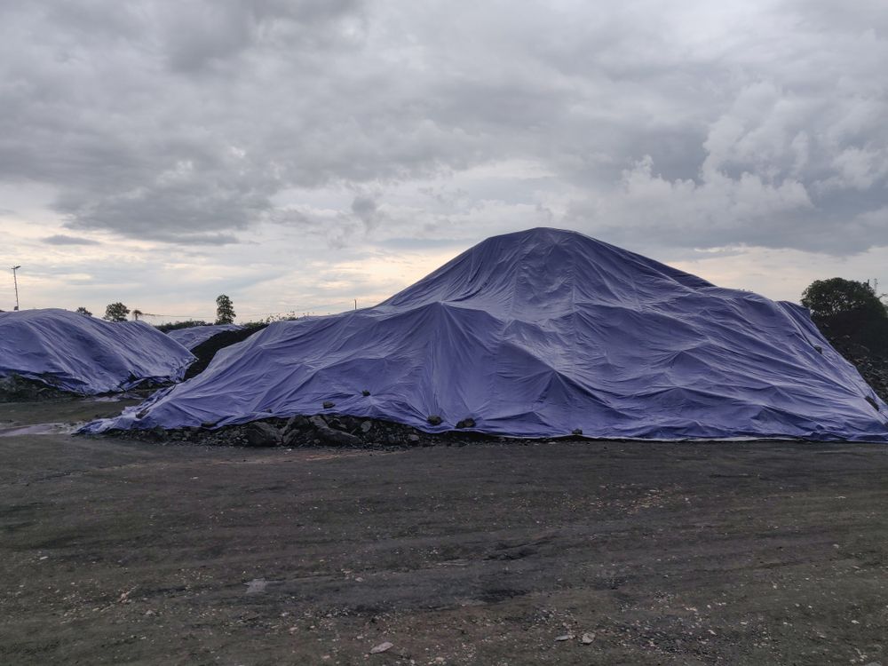 Large Piles of Material, Covered With Blue Tarps — Canobolas Canvas In Orange, NSW