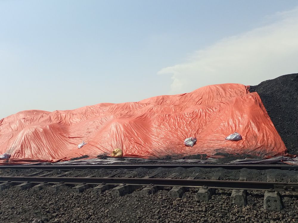 Pile of Black Coal Covered by an Orange Tarp — Canobolas Canvas In Orange, NSW