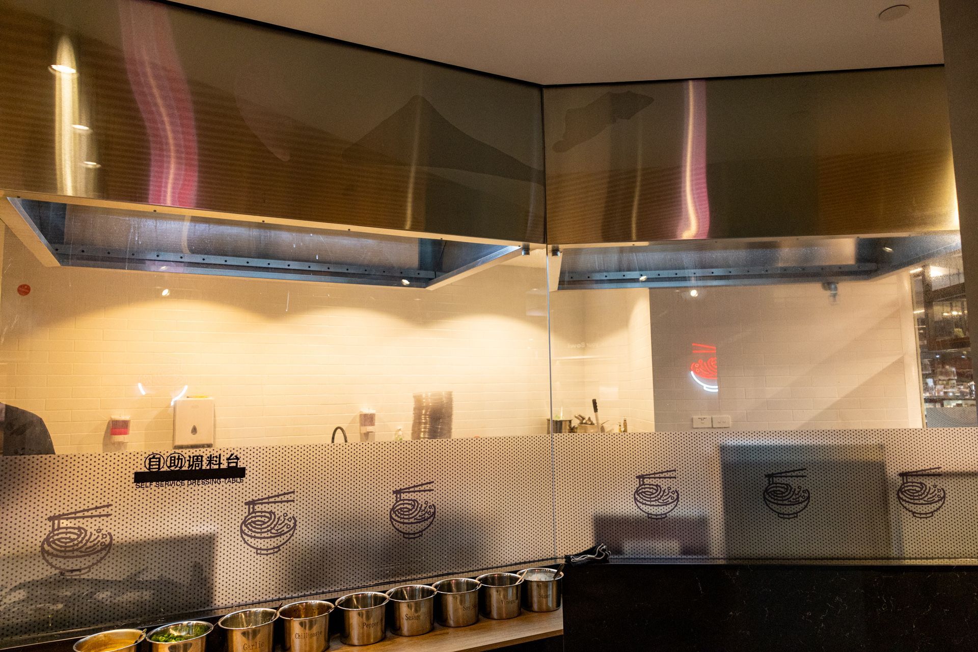 A kitchen with a lot of pots and pans on the counter