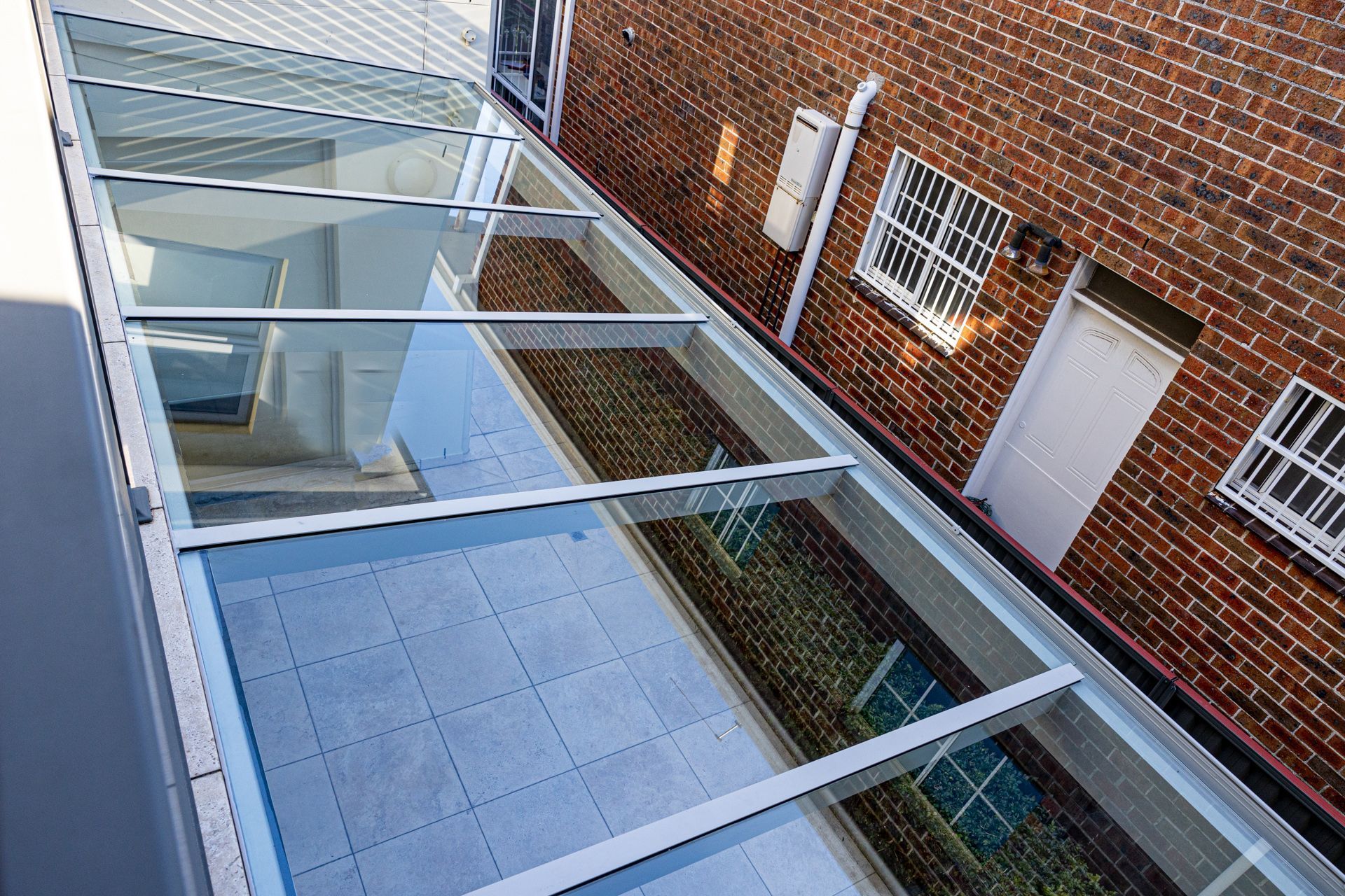An aerial view of a brick building with a glass roof.