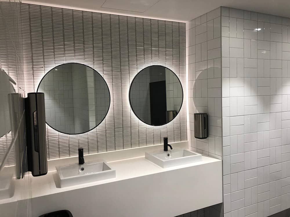 A bathroom with two sinks and two mirrors.
