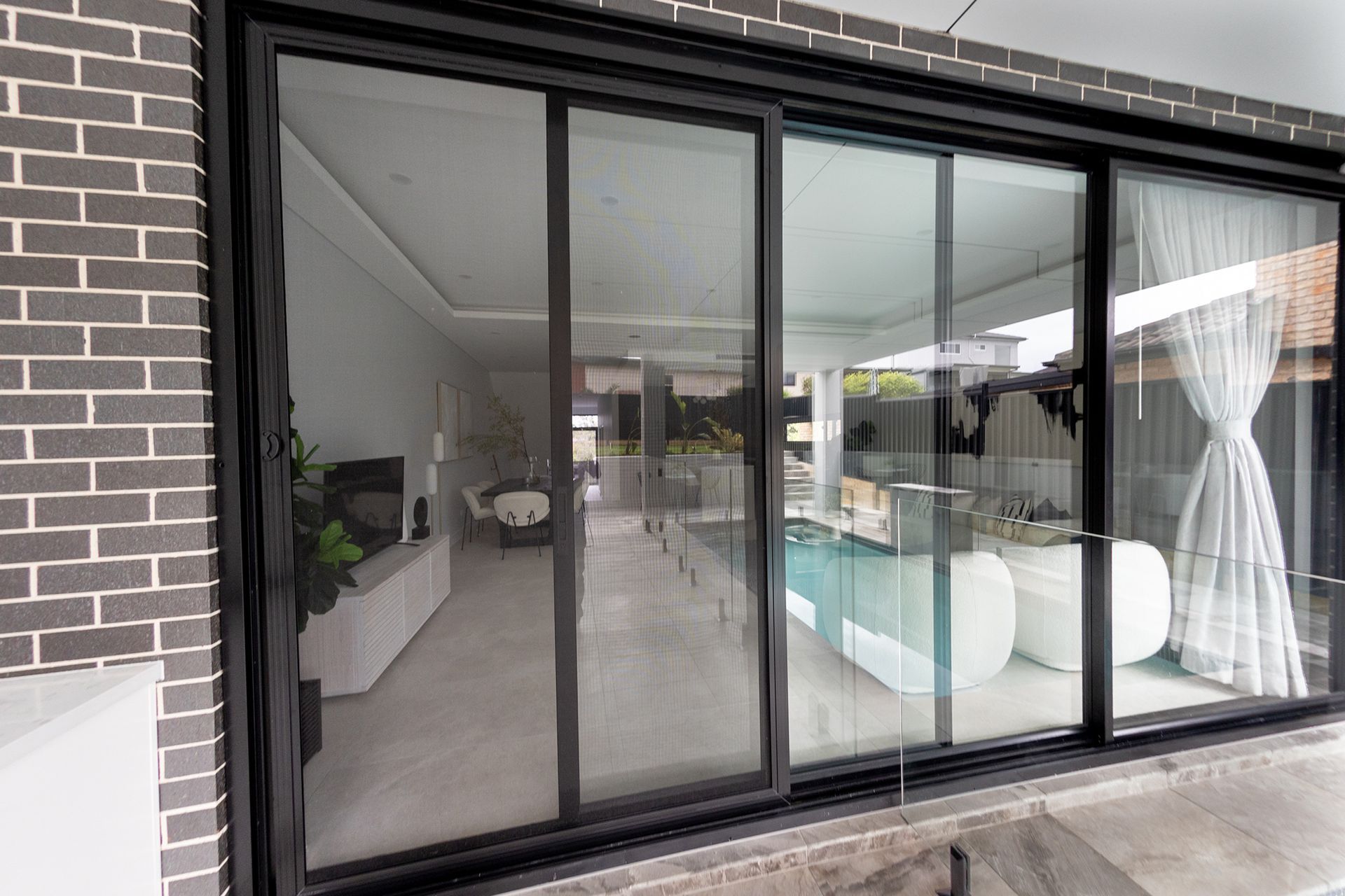 A large sliding glass door is open to a living room.