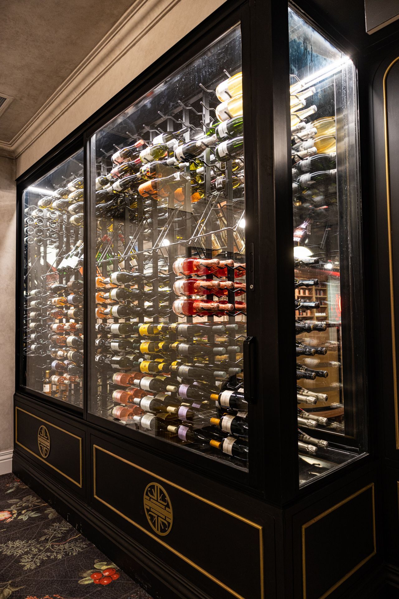 A large wine cooler filled with lots of wine bottles.
